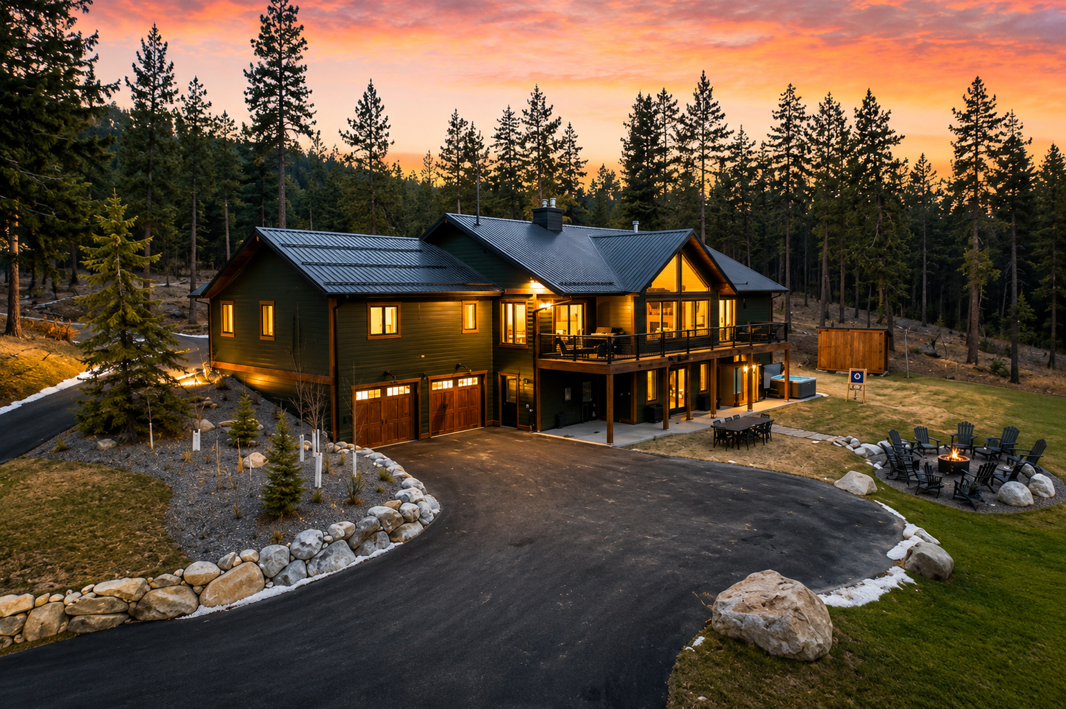 Aerial view of The Tamarack at sunset with the circular drive, fire pit and pines