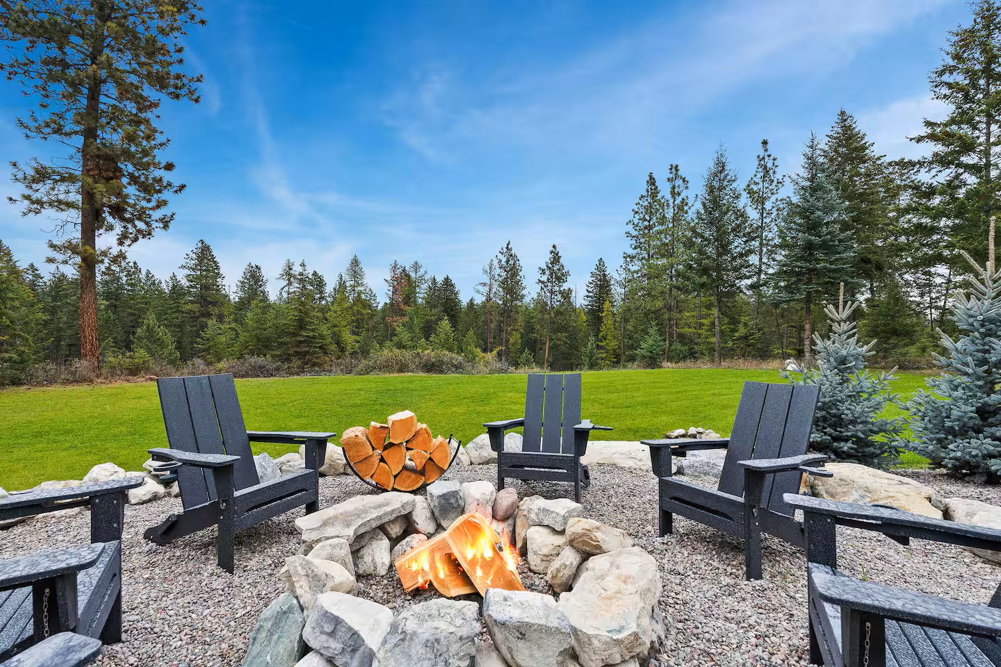 Stone fire pit and outdoor seating in the backyard