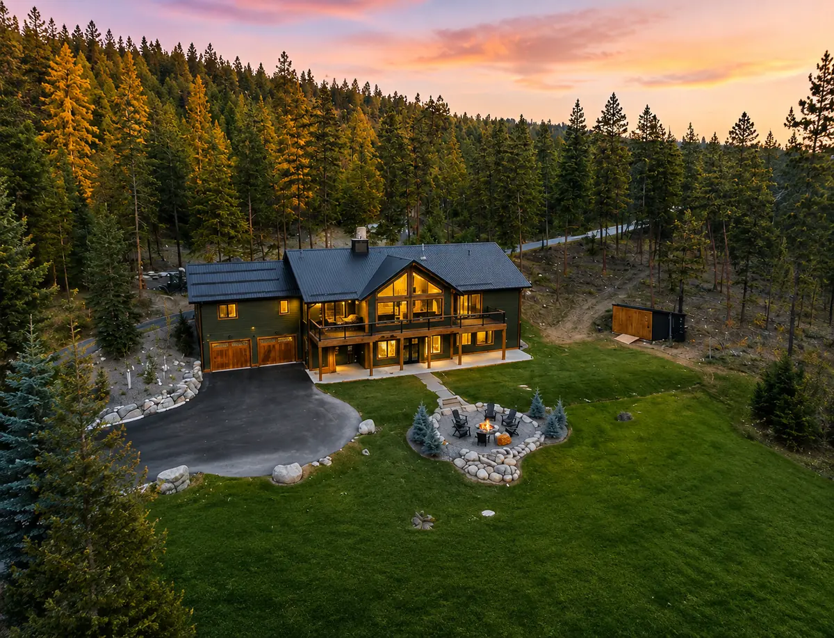 Aerial view of The Tamarack and its lawn, fire pit and forest setting